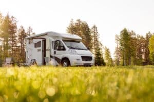 A caravan parked near a forest