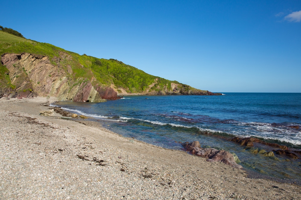 The secluded Talland Bay on a sunny day in Cornwall.